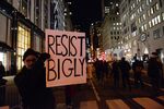 Protesters hold up sign at a rally against Trump in New York City.
