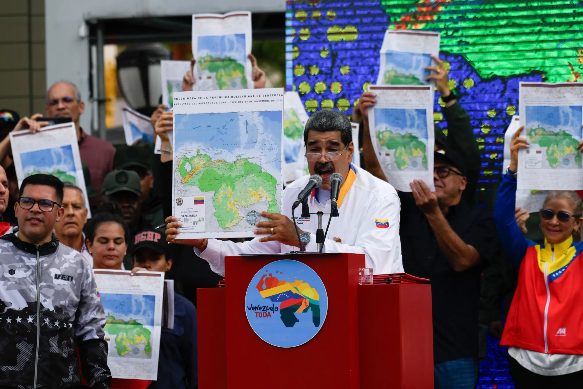 Nicolas Maduro shows a national map during a march in Caracas, Dec. 8.