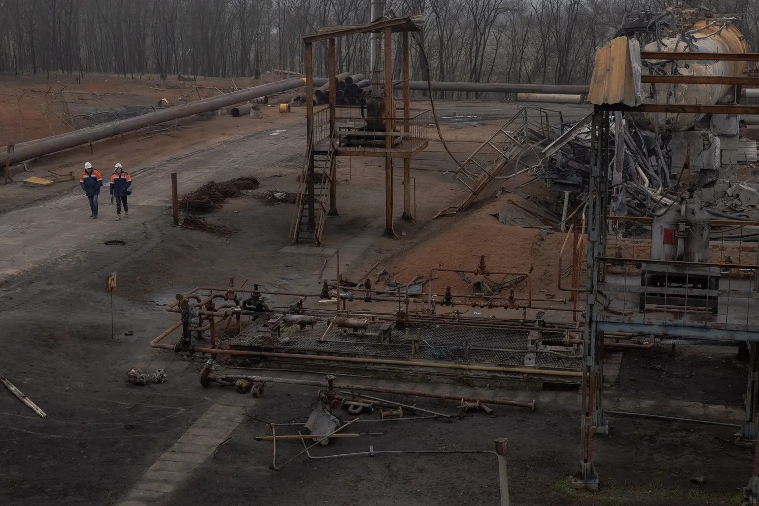 Employees walk past damaged parts of the Naftogaz gas facility&nbsp;following a Russian missile and drone attack&nbsp;in Ukraine, on Dec. 2.&nbsp;