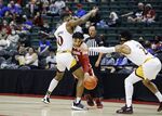 Alabama guard Jahvon Quinerly drives between Iona guards Berrick JeanLouis, left, and Elijah Joiner, right, during the first half of an NCAA college basketball game Thursday, Nov. 25, 2021, in Orlando, Fla. (AP Photo/Jacob M. Langston)