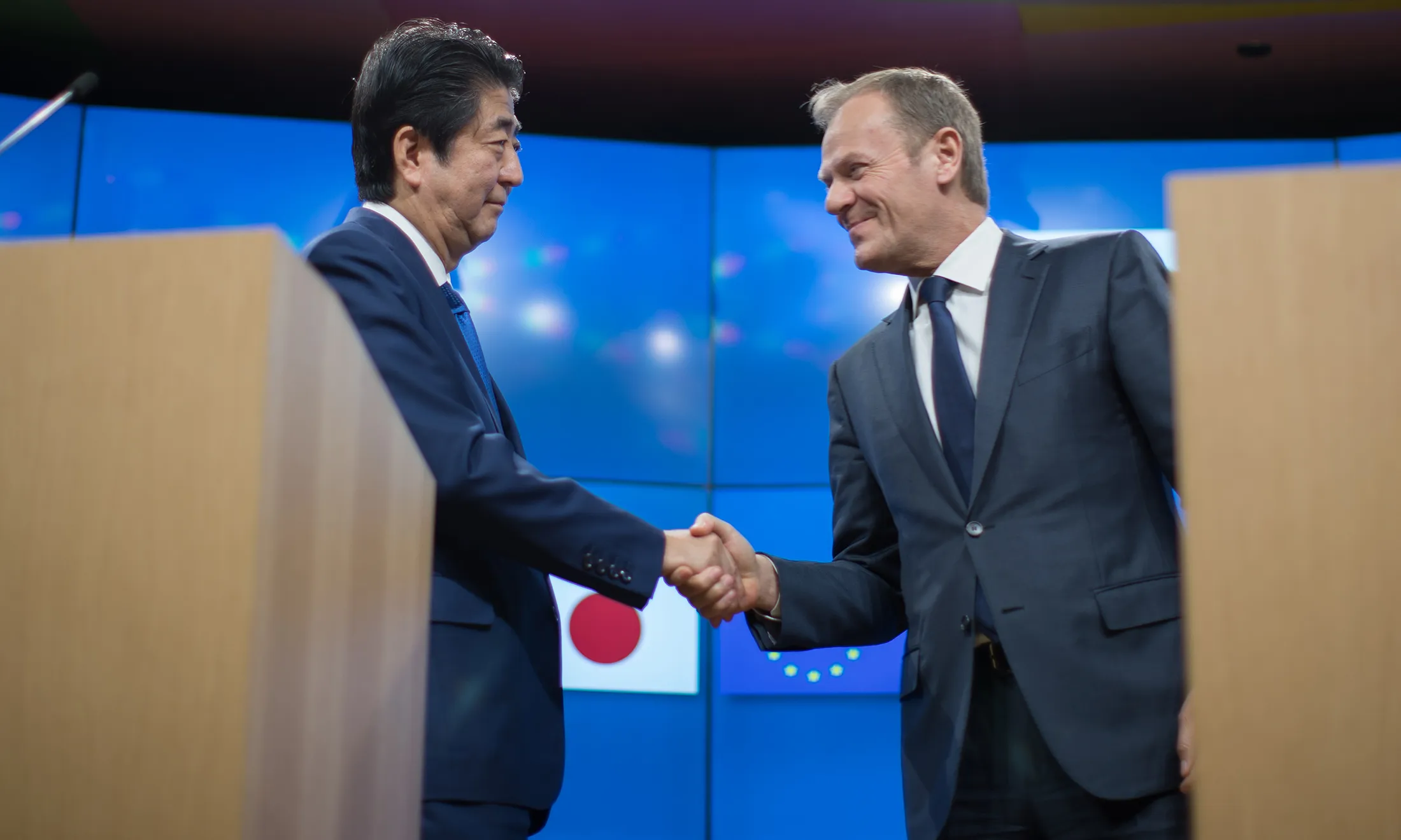 Shinzo Abe, Japan's prime minister, left, greets Donald Tusk, president of the European Union, ahead of a news conference at the European Council in Brussels, Belgium, on March 21, 2017.
