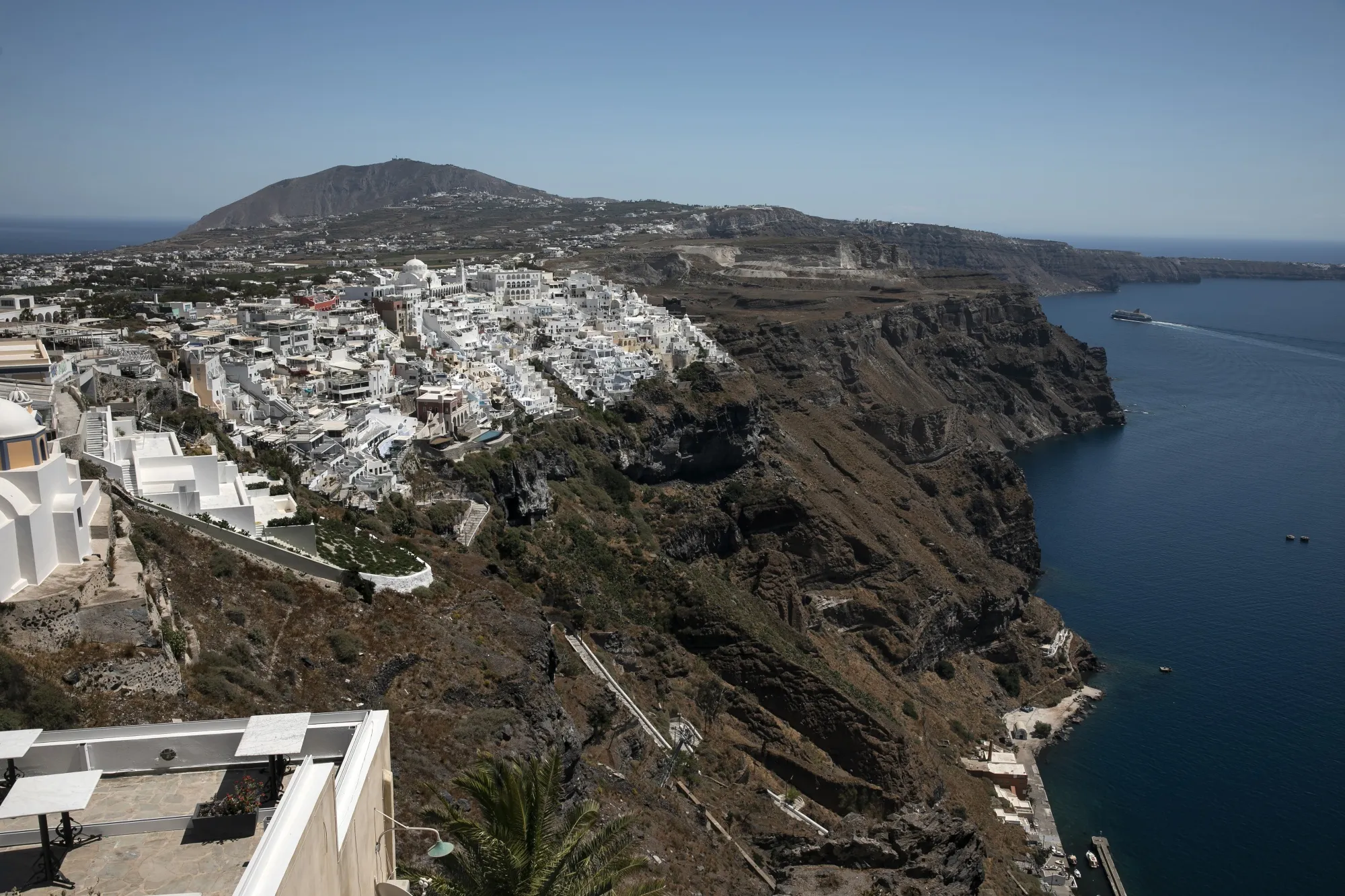 A passenger ship approaches the port at the island of Santorini, Greece.