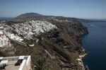 A passenger ship approaches the port at the island of Santorini, Greece.