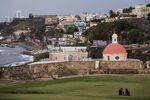 A domed building in the Santa María Magdalena de Pazzis Cemetery is seen from the Castillo San Felipe del Morro in San Juan, Puerto Rico, on Sunday, May 1, 2016. Puerto Rico will default on a $422 million bond payment for its Government Development Bank, escalating what is turning into the biggest crisis ever in the $3.7 trillion market that state and local entities use to access financing.
