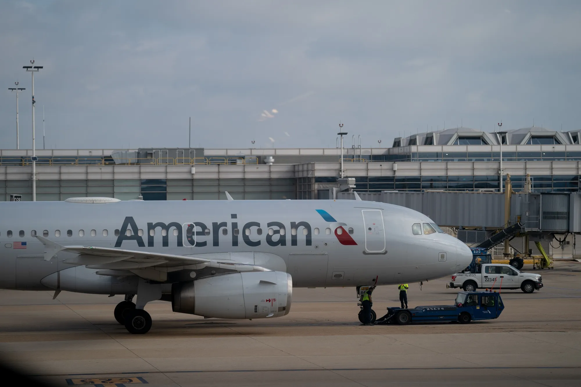 Workers near an American Airlines plane at Ronald Reagan Washington National Airport in Arlington, Virginia.