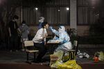 A medical worker swabs a resident during Covid-19 testing in a neighborhood placed under lockdown in Shanghai, China, on April 12.