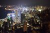 The Bank of China Tower, center left, and other commercial buildings stand illuminated at night in this photograph taken with a tilt-shift lens at night in Hong Kong, China.