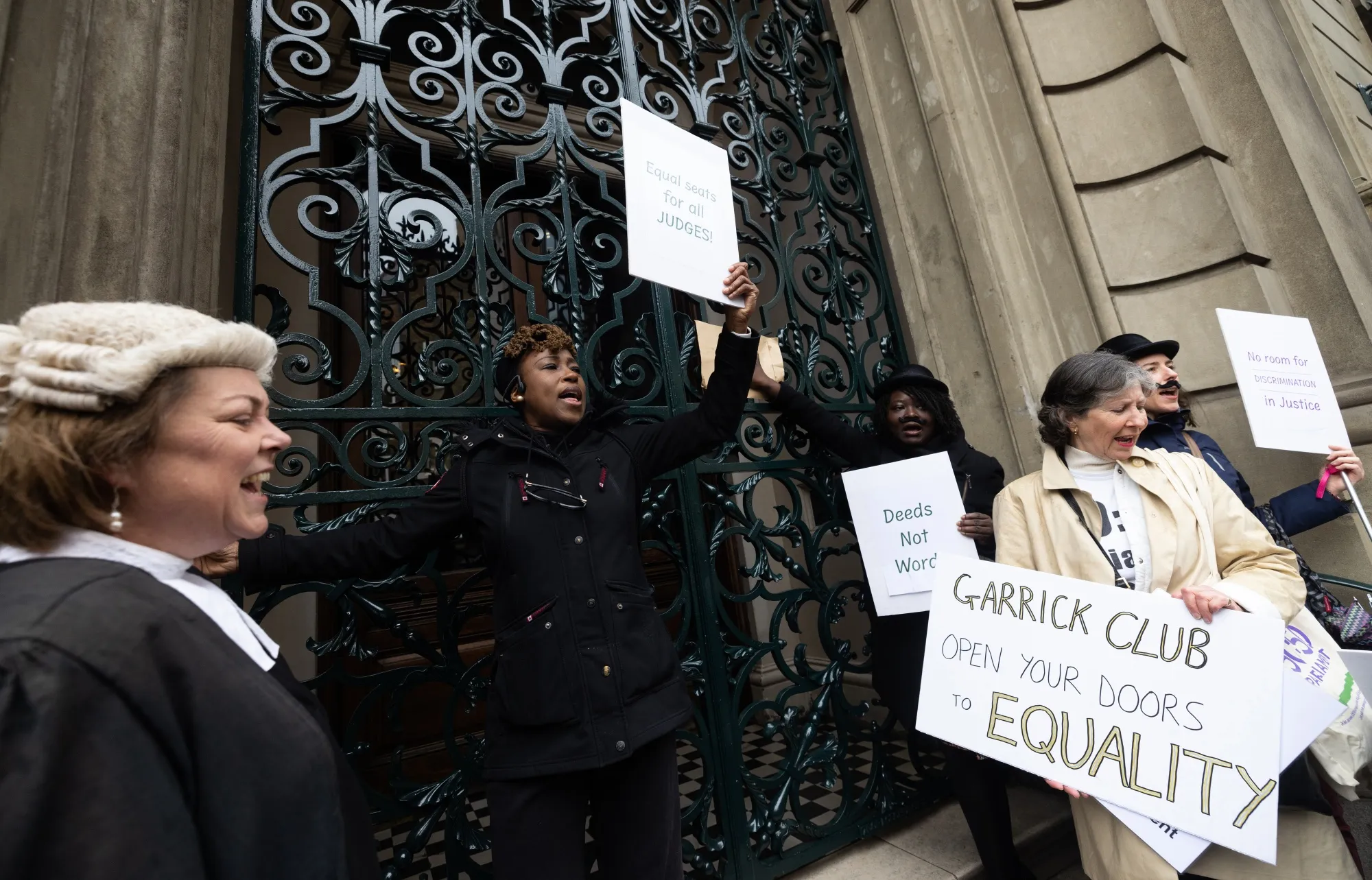 Women protest outside the Garrick Club in London.