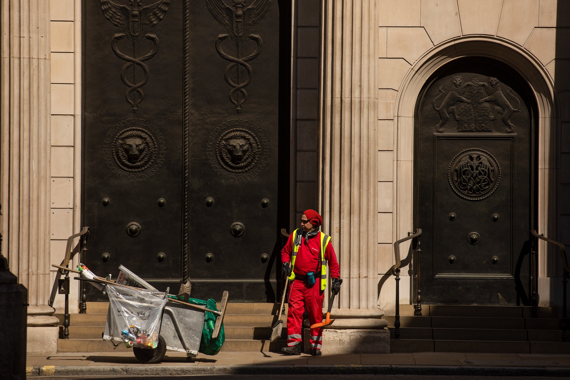 A municipal worker cleans the street outside the Bank of England in the City of London.