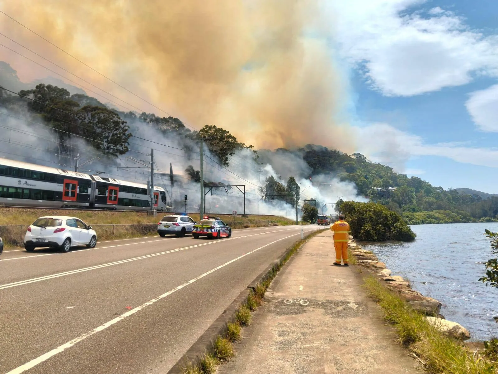 Flames rise as train lines passing through affected areas is cut off due to bushfires in New South Wales on Dec. 6.