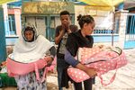 A man&nbsp;stands next to members of his family who holds his twin nieces who were born during the hostilities, in Wukro, north of Mekele, on March 1.