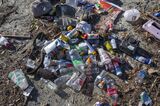 Recent storms wash heaps of debris and trash down the San Gabriel River straight onto local beaches and into the ocean