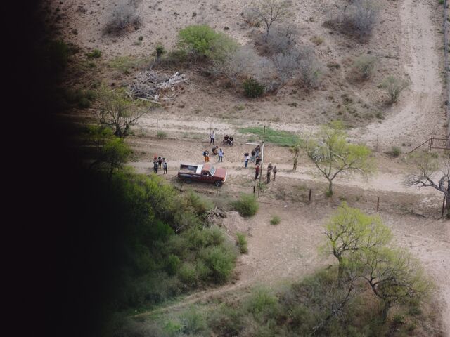 A Texas Department of Safety helicopter spots law enforcement detaining migrants at the border.