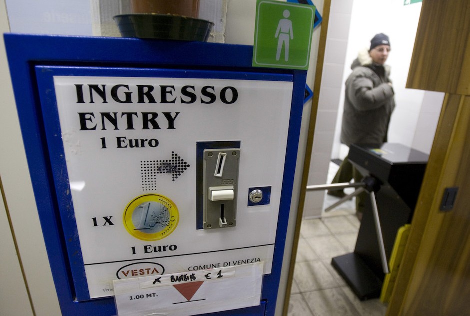 A man leaves a pay toilet in Venice, Italy.