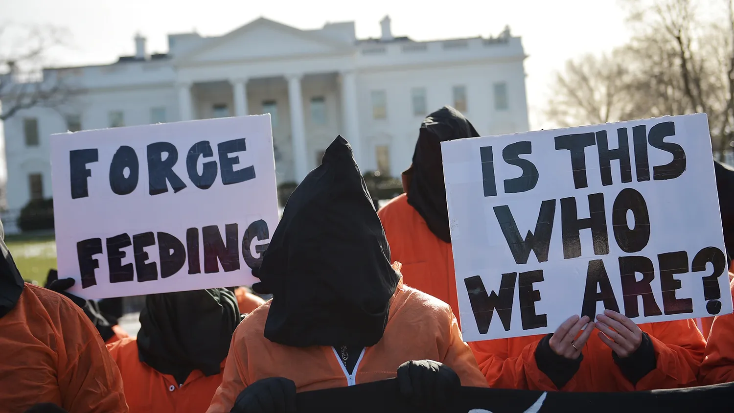 Hooded protestors take part in a demonstration against the Guantanamo Bay detention facility on Jan. 11, 2015, outside of the White House in Washington.
