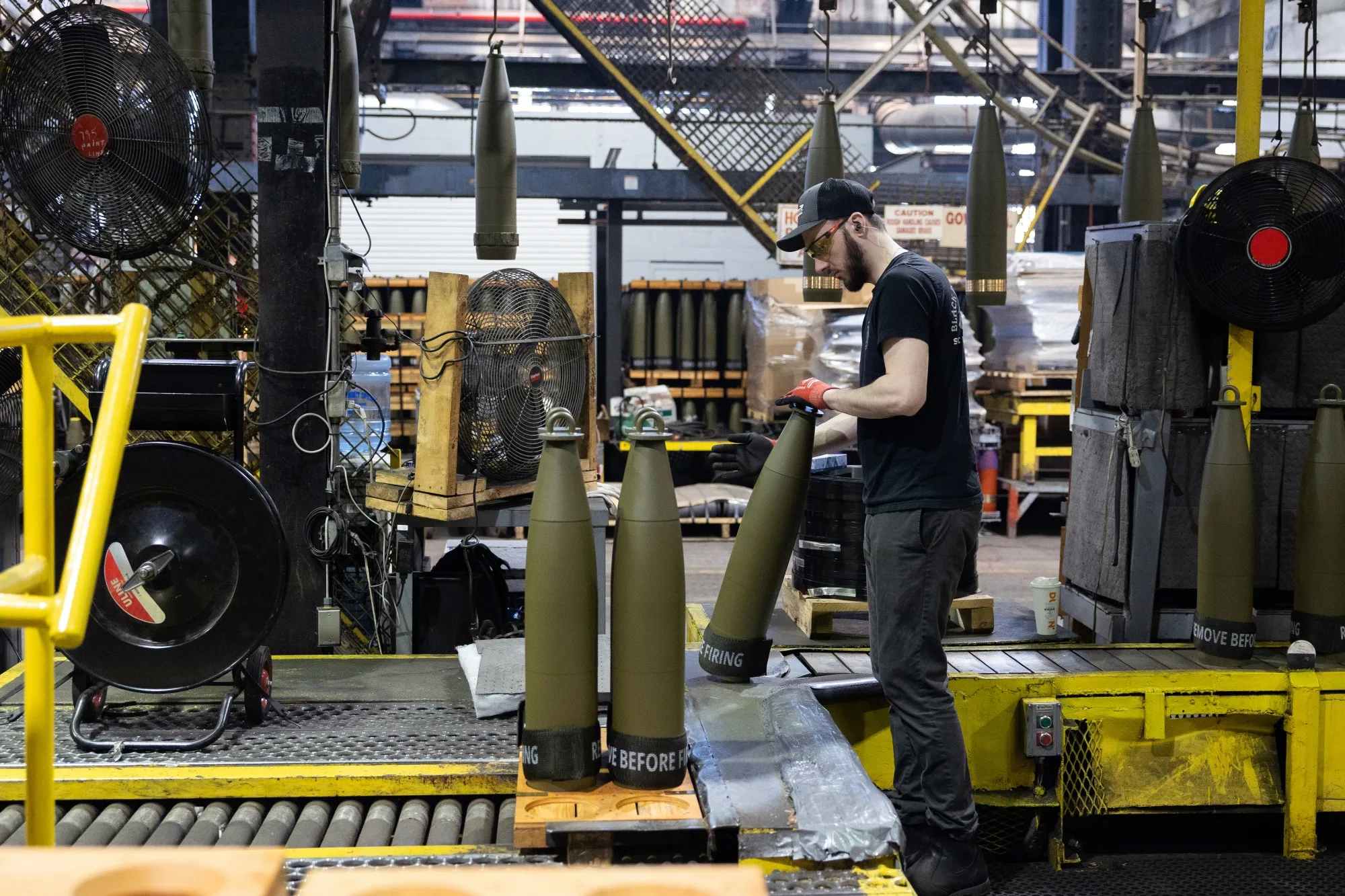An employee places painted projectiles on pallets at the Scranton Army Ammunition Plant in Scranton, Pennsylvania.