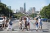 Pedestrians cross South Congress Avenue with the downtown skyline seen in the background in Austin, Texas, U.S., on Saturday, July 23, 2016. Consumer confidence was little changed in July as Americans remained positive about the job market and the business environment, according to a report from the New York-based Conference Board on Tuesday.