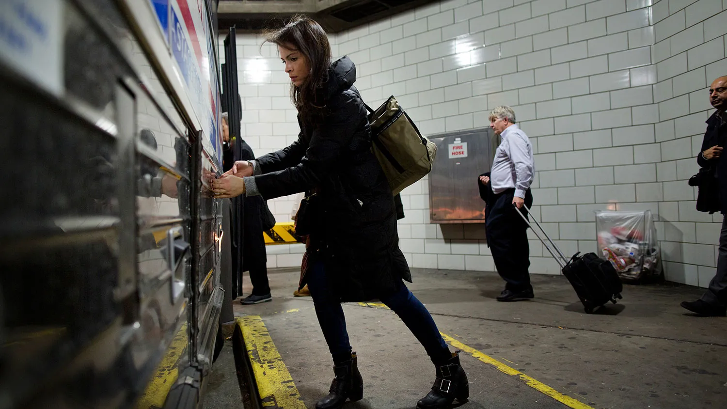 Commuters board a bus at the Port Authority Bus Terminal during rush hour in New York on Dec. 12, 2014.
