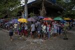 People out of work due line up to receive government cash handouts in Rodriguez town, Rizal province on May 11.