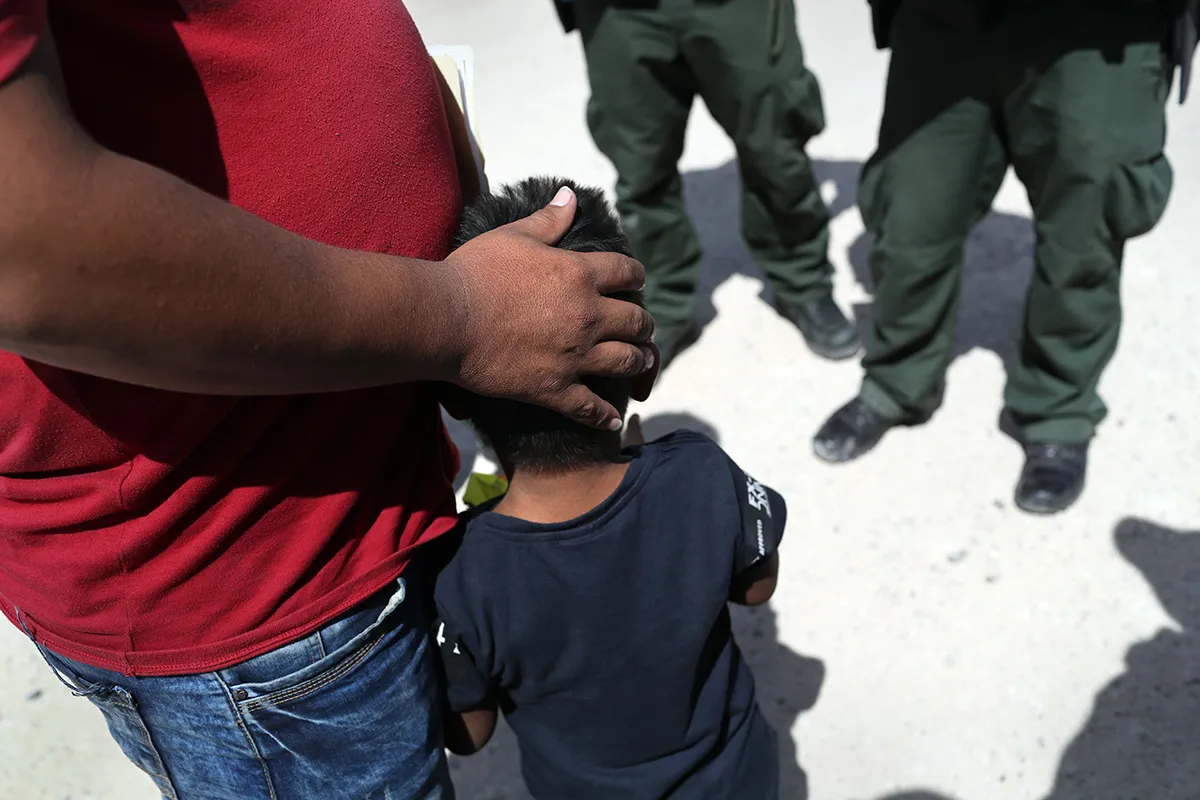 U.S. Border Patrol agents take a father and son from Honduras into custody near the U.S.-Mexico border on June 12, 2018 near Mission, Texas.