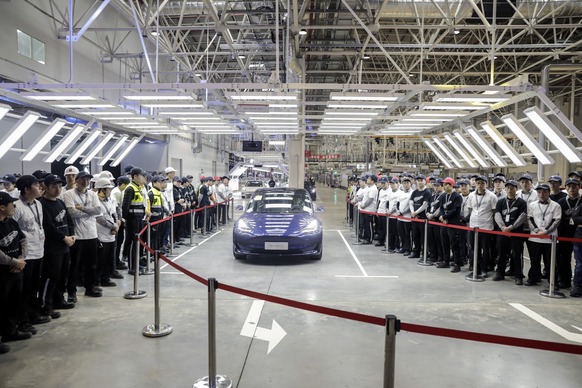 A Model 3 vehicle leaves an assembly line during a ceremony at Tesla's Gigafactory in Shanghai, December 2019.