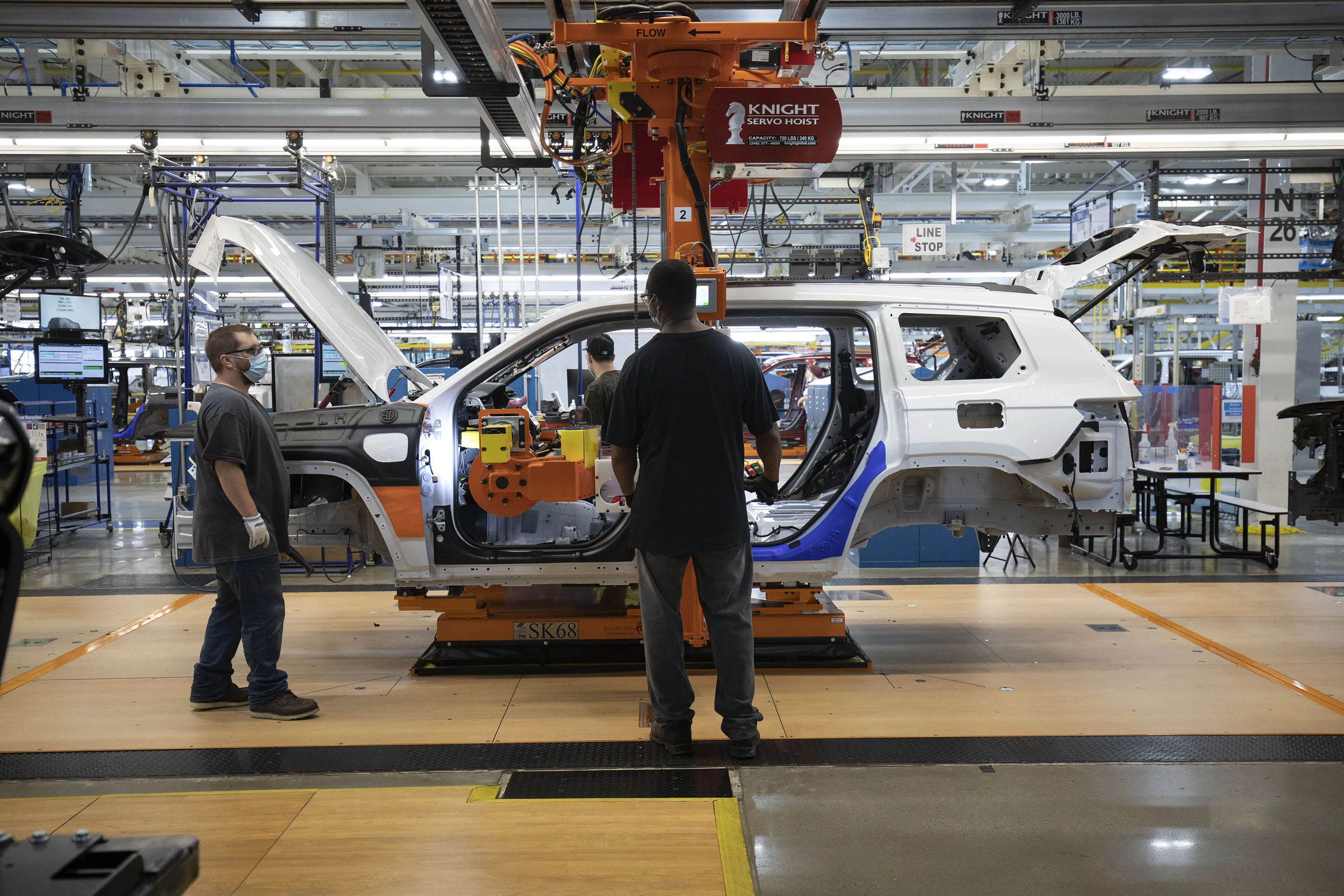 Stellantis workers put doors on a Jeep vehicle&nbsp;at the Stellantis Detroit Assembly Complex-Mack&nbsp;in Detroit, Michigan.&nbsp;