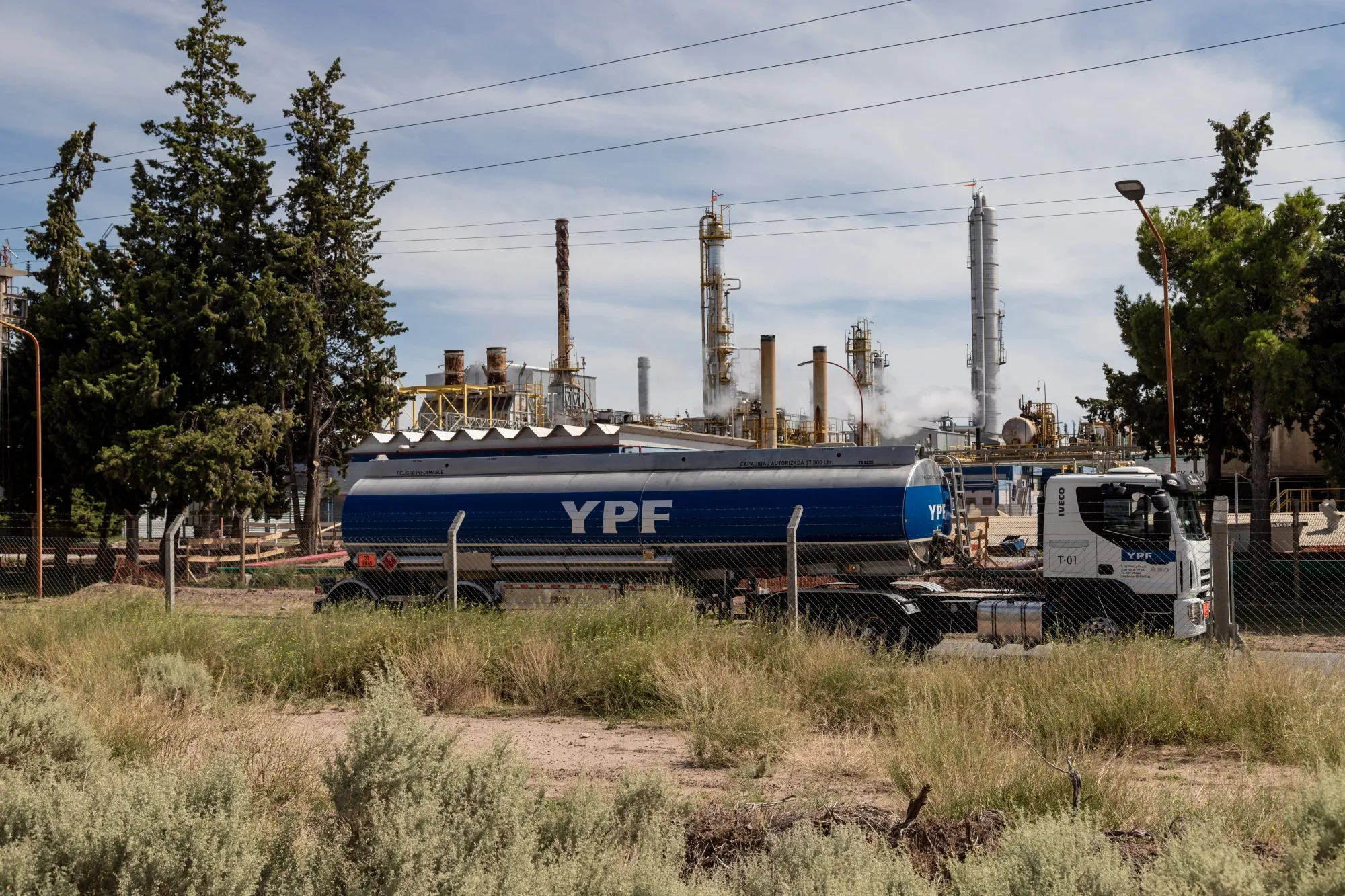A truck passes a YPF SA facility in Plaza Huincul, Neuquen province, Argentina.