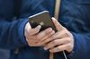 A customer views an Apple Inc. iPhone X smartphone during the sales launch.