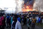 Shops burn during a protest in Wamena in Papua province on Sept 23.
