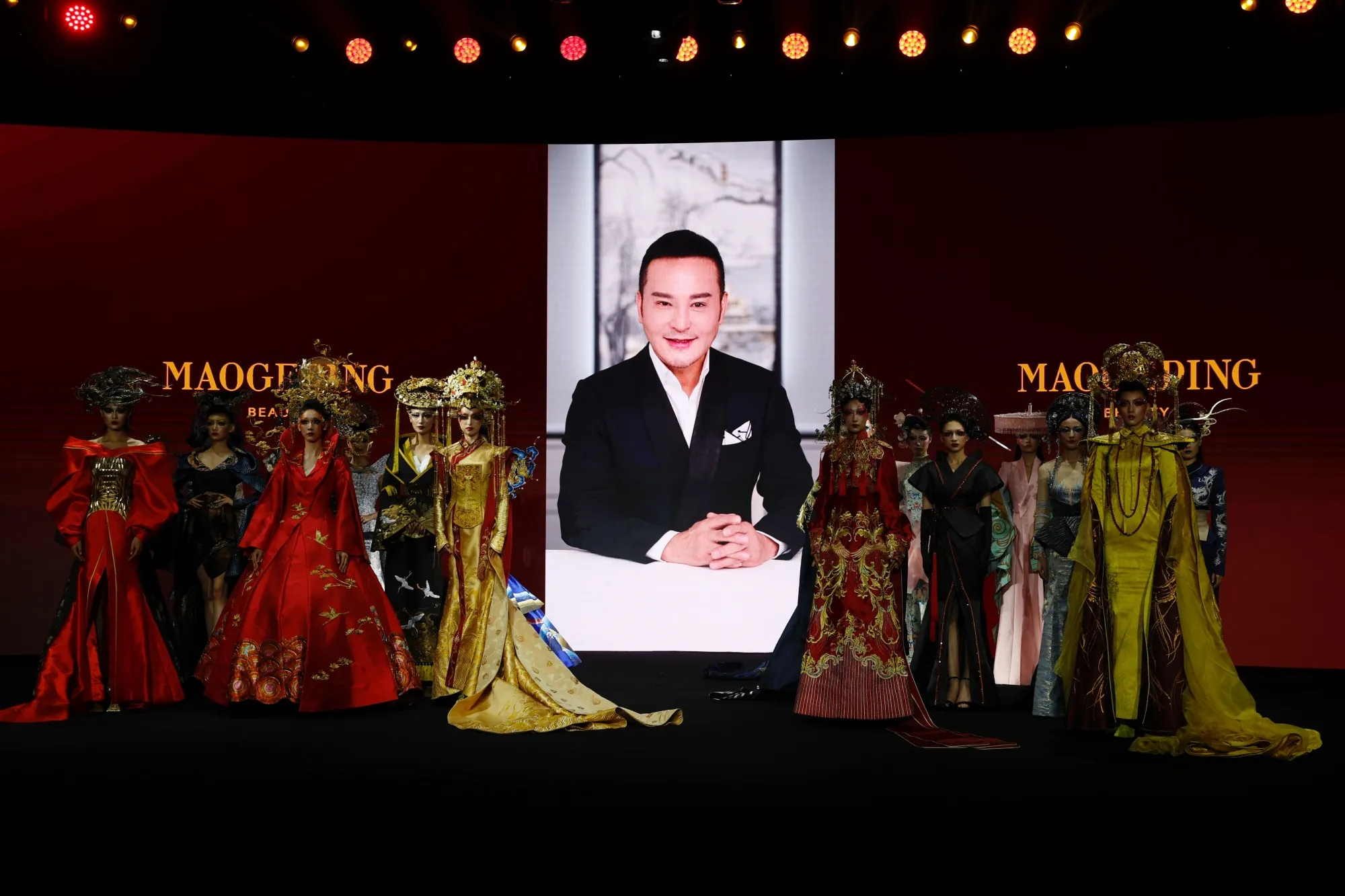Models showcase designs on the runway at a show by Mao Geping during Beijing Fashion Week in 2022.