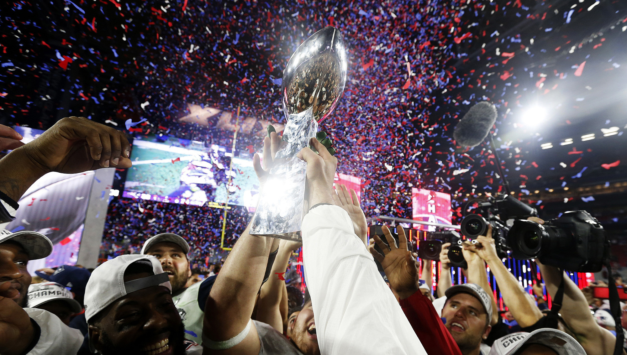 Members of the New England Patriots celebrate with the Vince Lombardi Trophy after defeating the Seattle Seahawks in Super Bowl XLIX in Glendale, Arizona, on Feb. 1, 2015.
