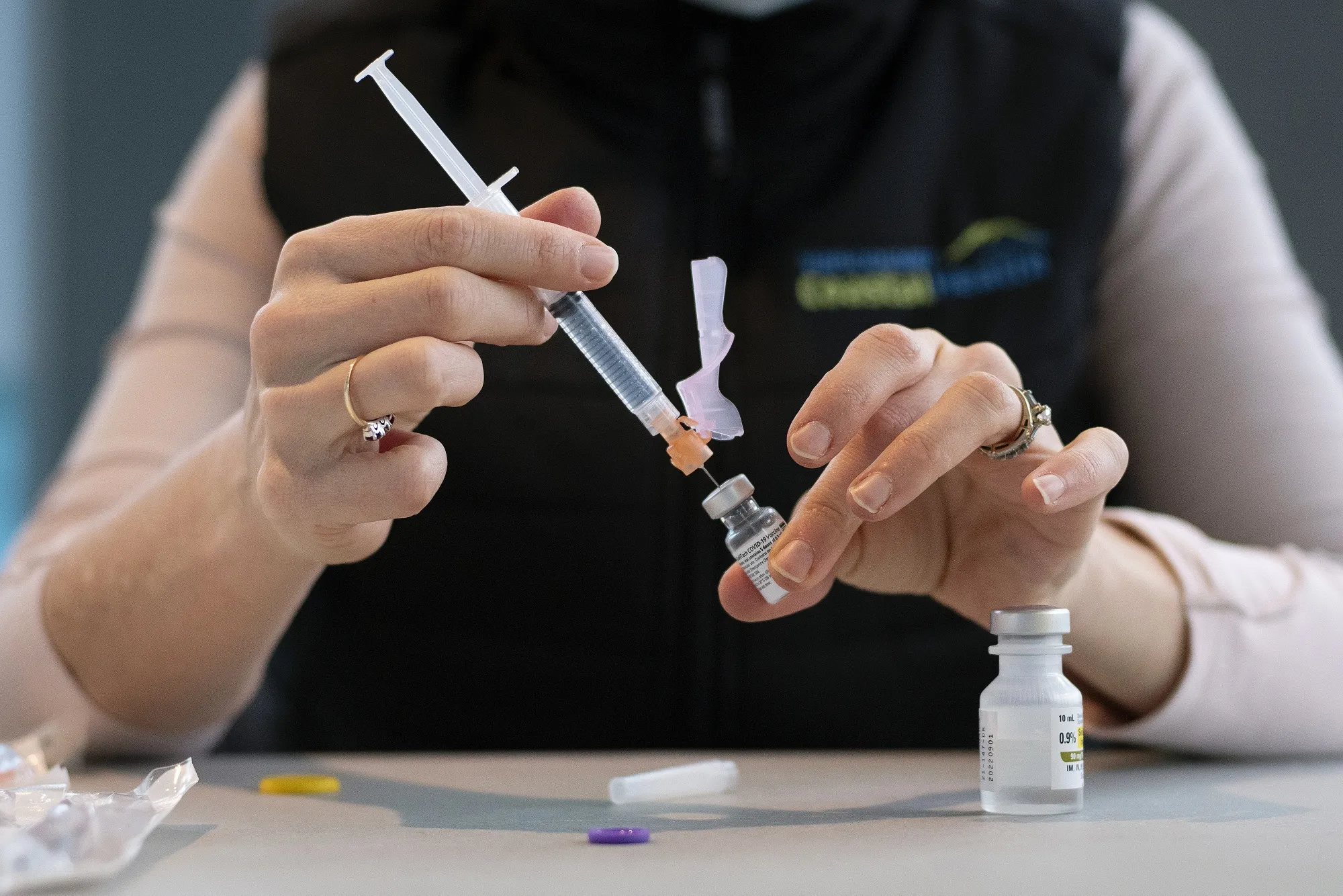 A healthcare worker fills a syringe with the Pfizer-BioNTech Covid-19 vaccine.&nbsp;