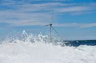 Wind turbines stand at an offshore wind farm