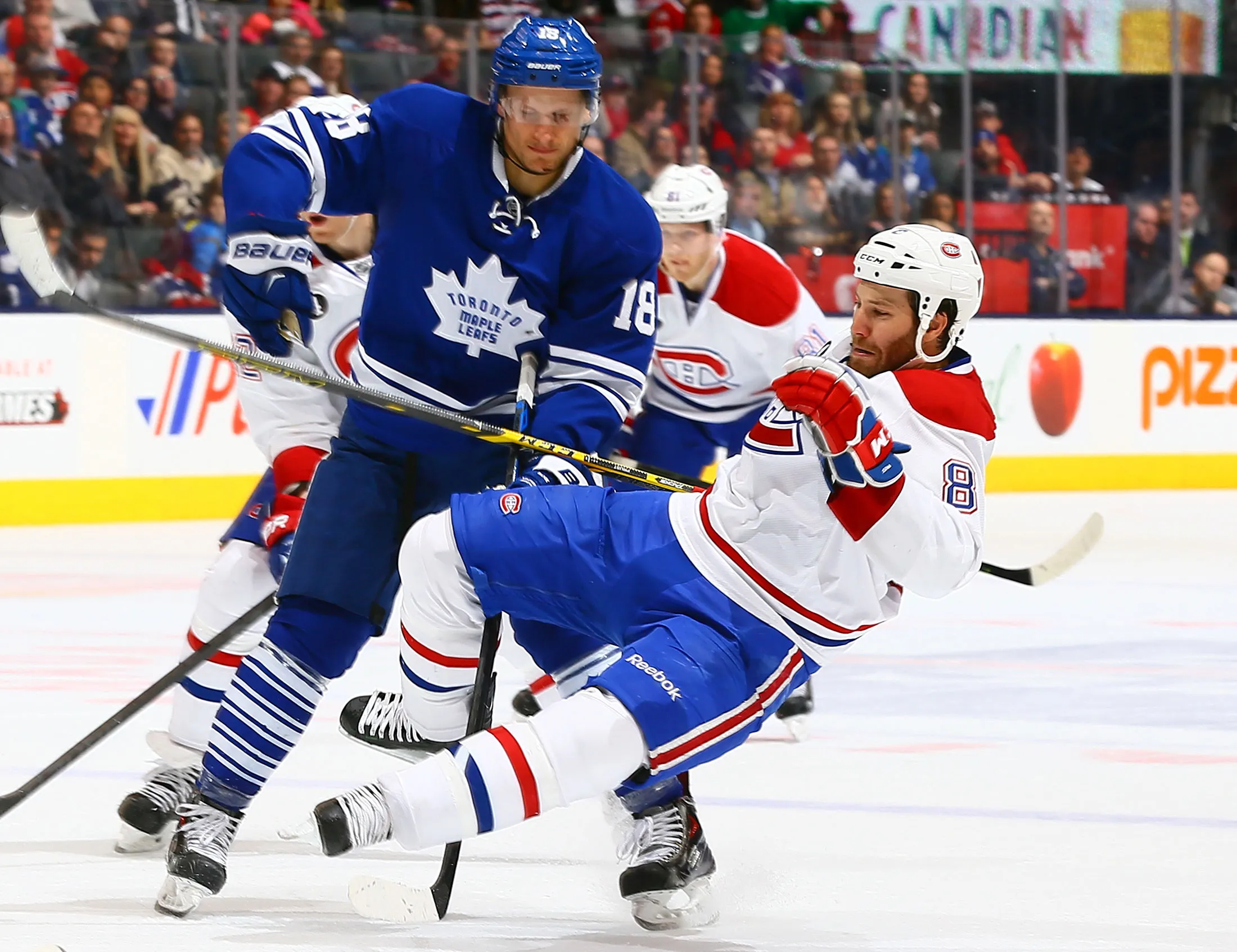Richard Panik #18 of the Toronto Maple Leafs runs into Brandon Prust #8 of the Montreal Canadiens during NHL action at the Air Canada Centre April 11, 2015 in Toronto, Ontario, Canada.
