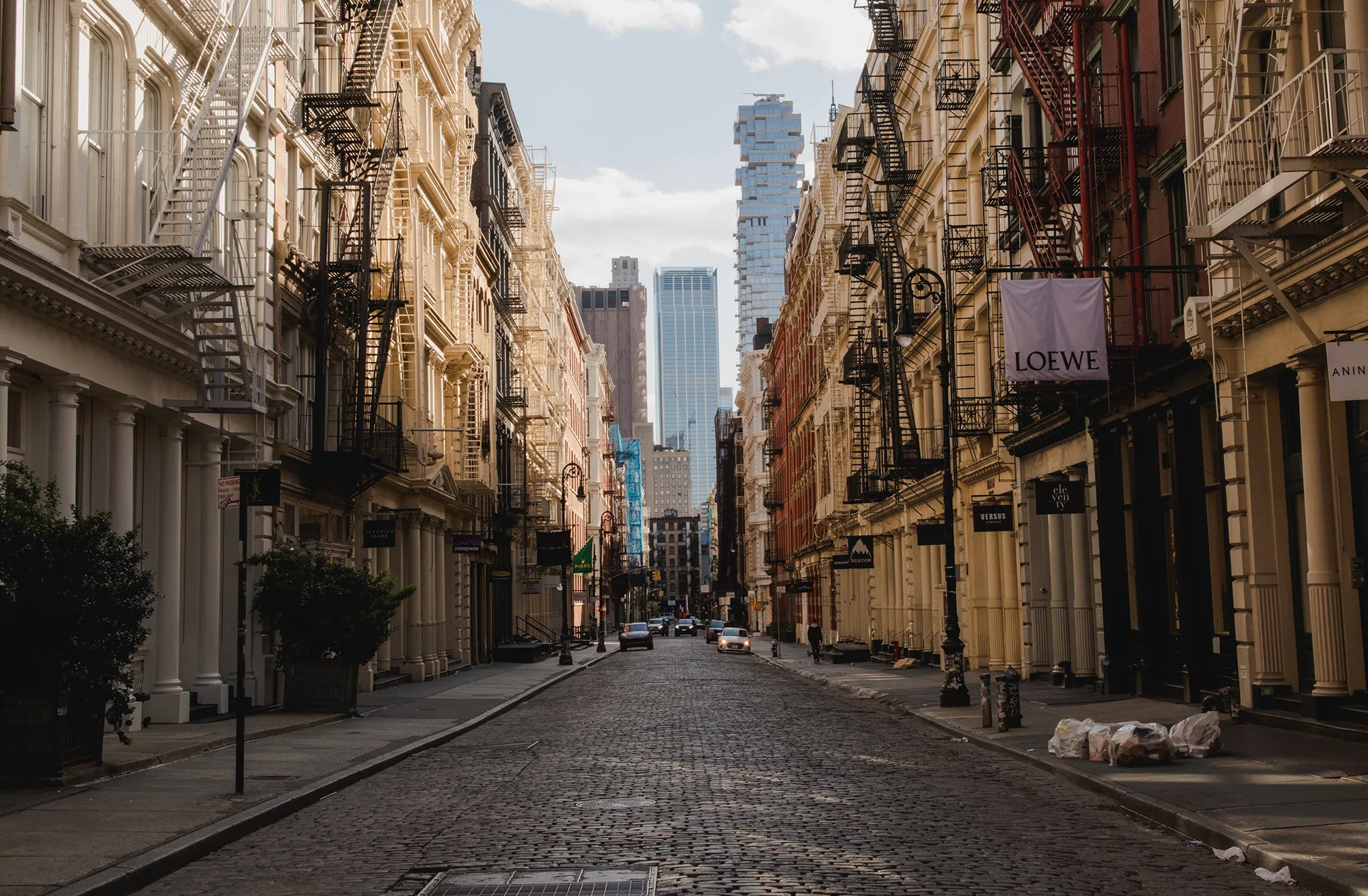 Retail stores stand closed along Greene Street in the Soho neighborhood of New York.