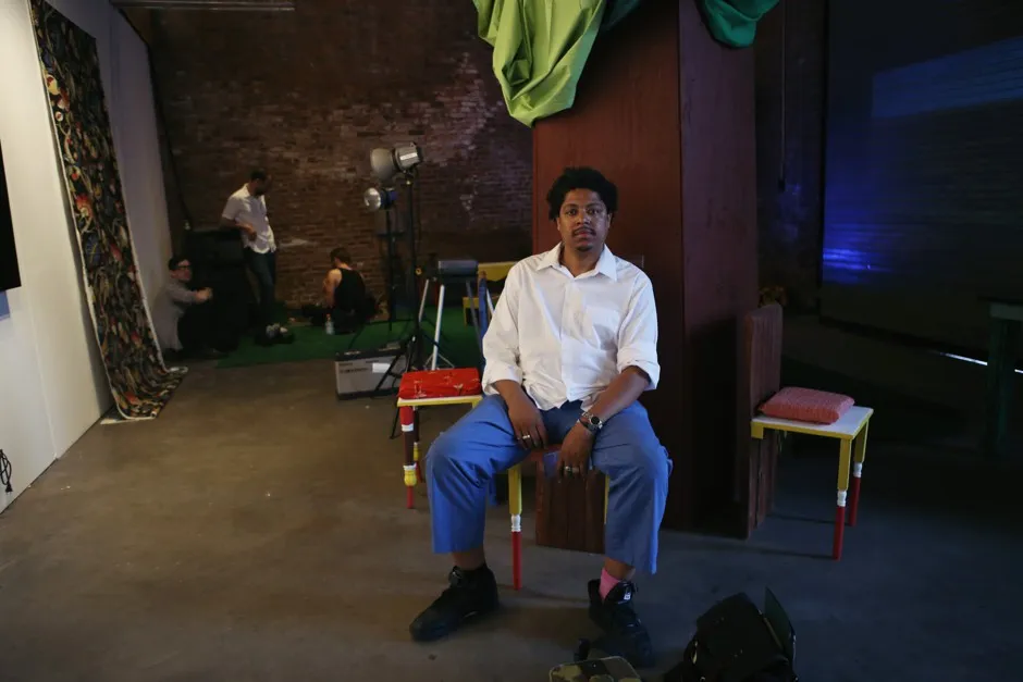 Azikiwe Mohammed sits in his installation of New Davonhaime
