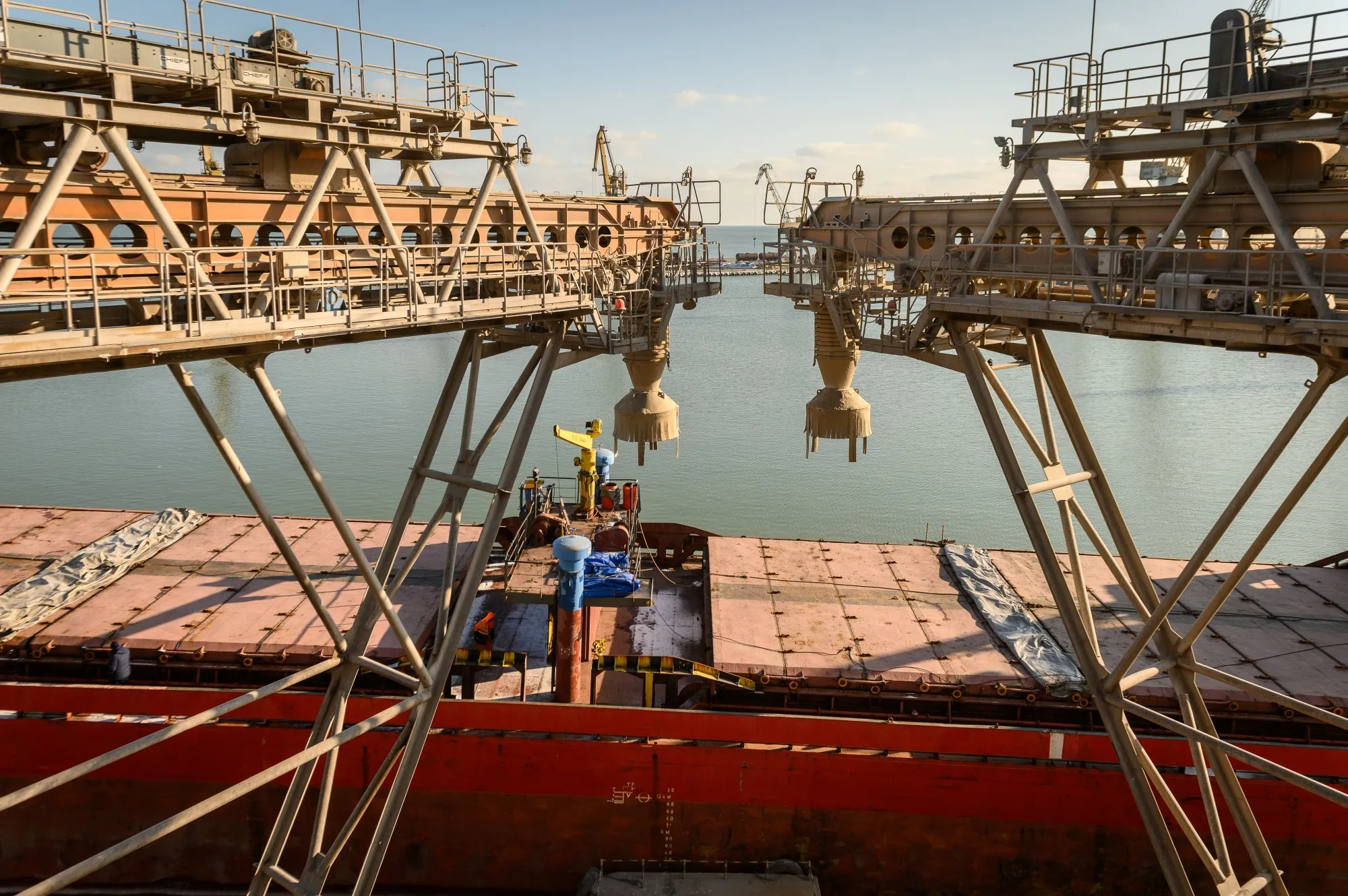 A cargo vessel is loaded with grain at a terminal in the Port of Mariupol, Ukraine, on Jan. 13.