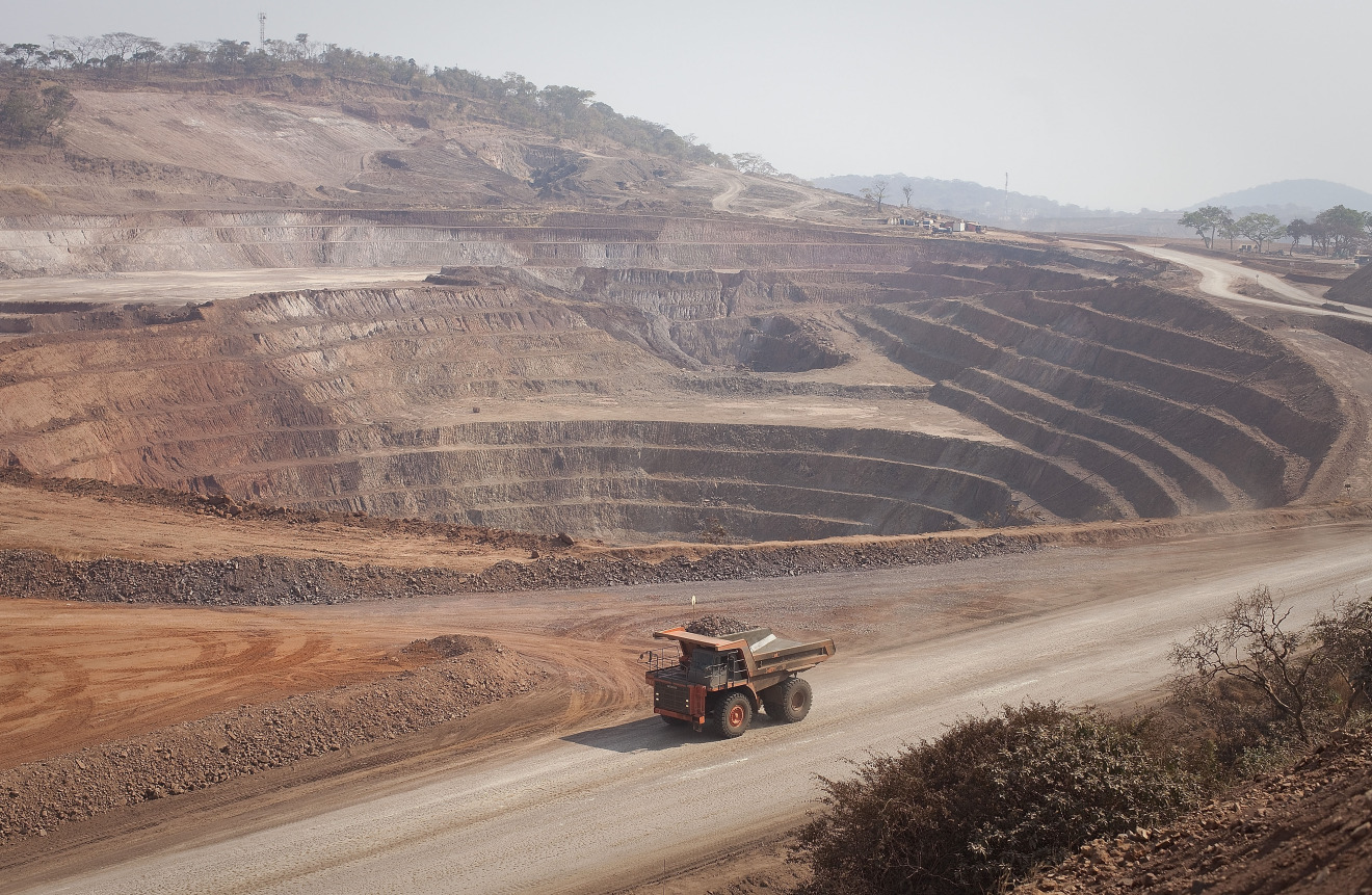 A mining truck drives past an open pit excavation at a copper and cobalt mine in Mutanda, Katanga province, Democratic Republic of Congo.