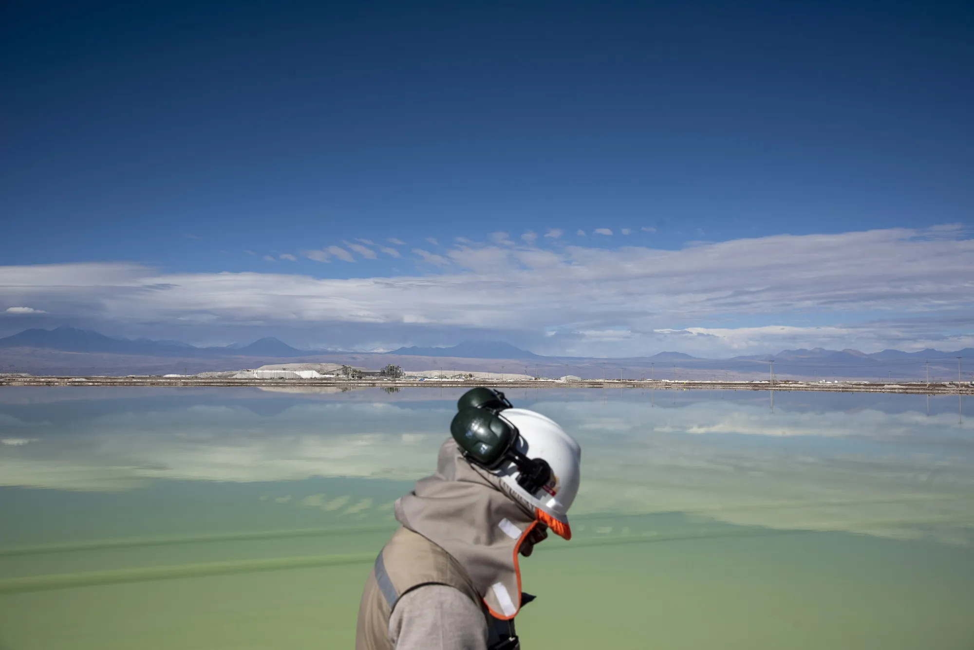 A visitor walks past a brine lake at a&nbsp;&nbsp;lithium mine&nbsp;in the Atacama Desert, Chile.