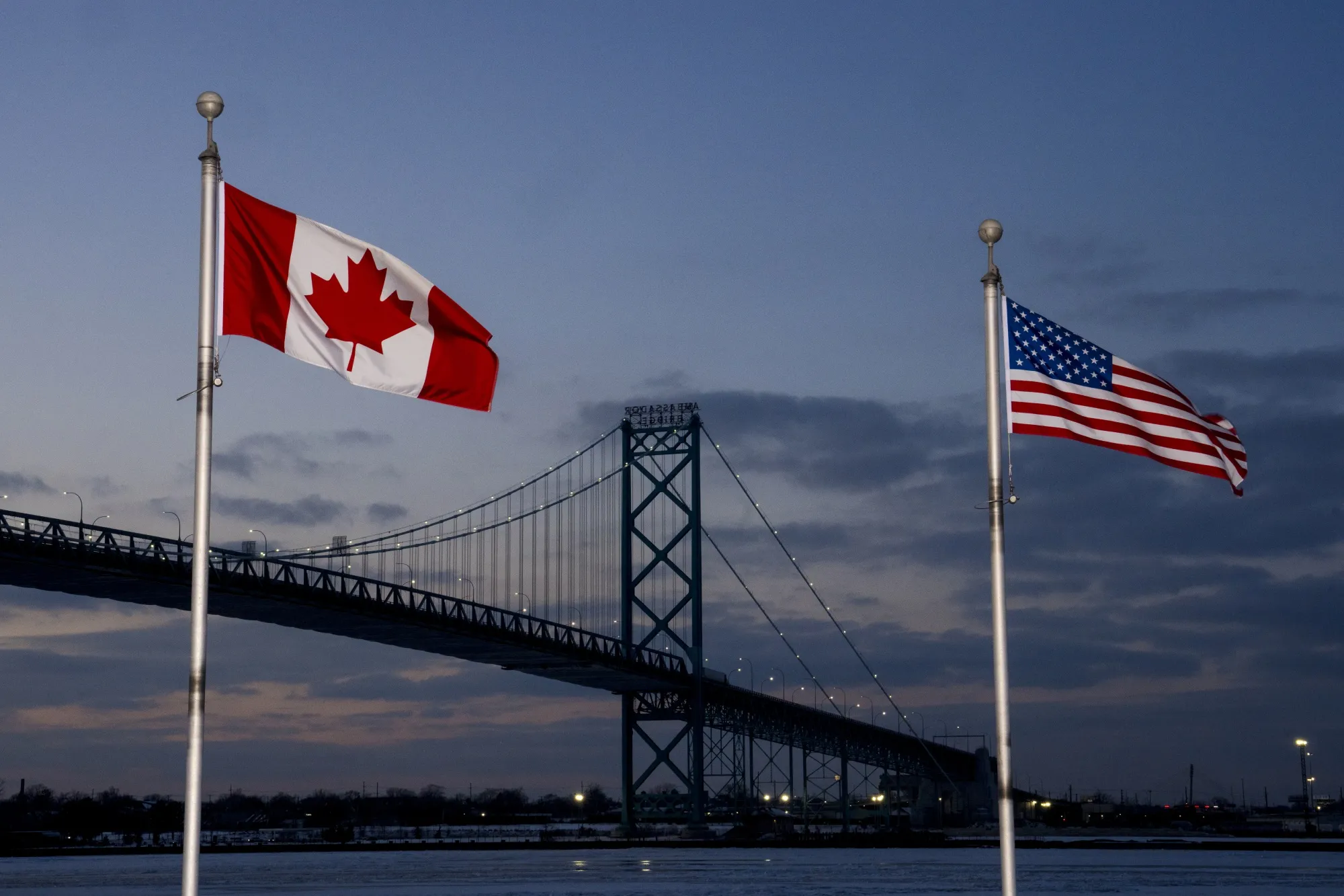 Canadian and American flags near the Ambassador Bridge in Windsor, Ontario, Canada.
