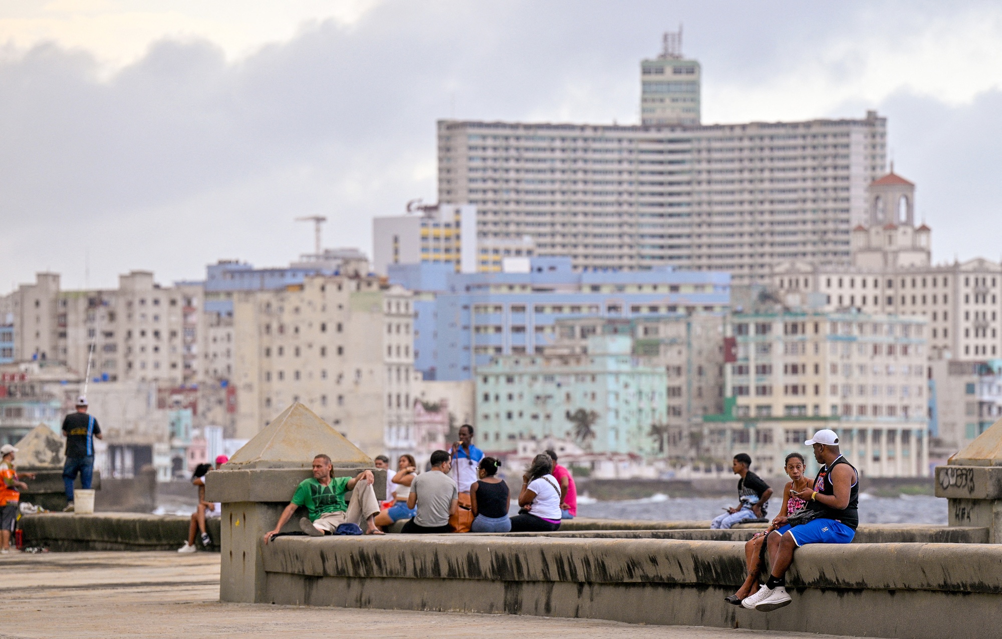People gather at the Malecon after a blackout in Havana on March 4. Photographer: ADALBERTO ROQUE/AFP