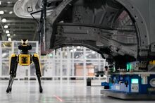 A Boston Dynamics robot named Spot uses a camera to scan for deformities in the body of a car.