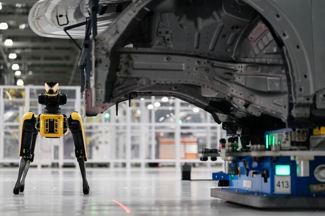 A Boston Dynamics robot named Spot uses a camera to scan for deformities in the body of a car.