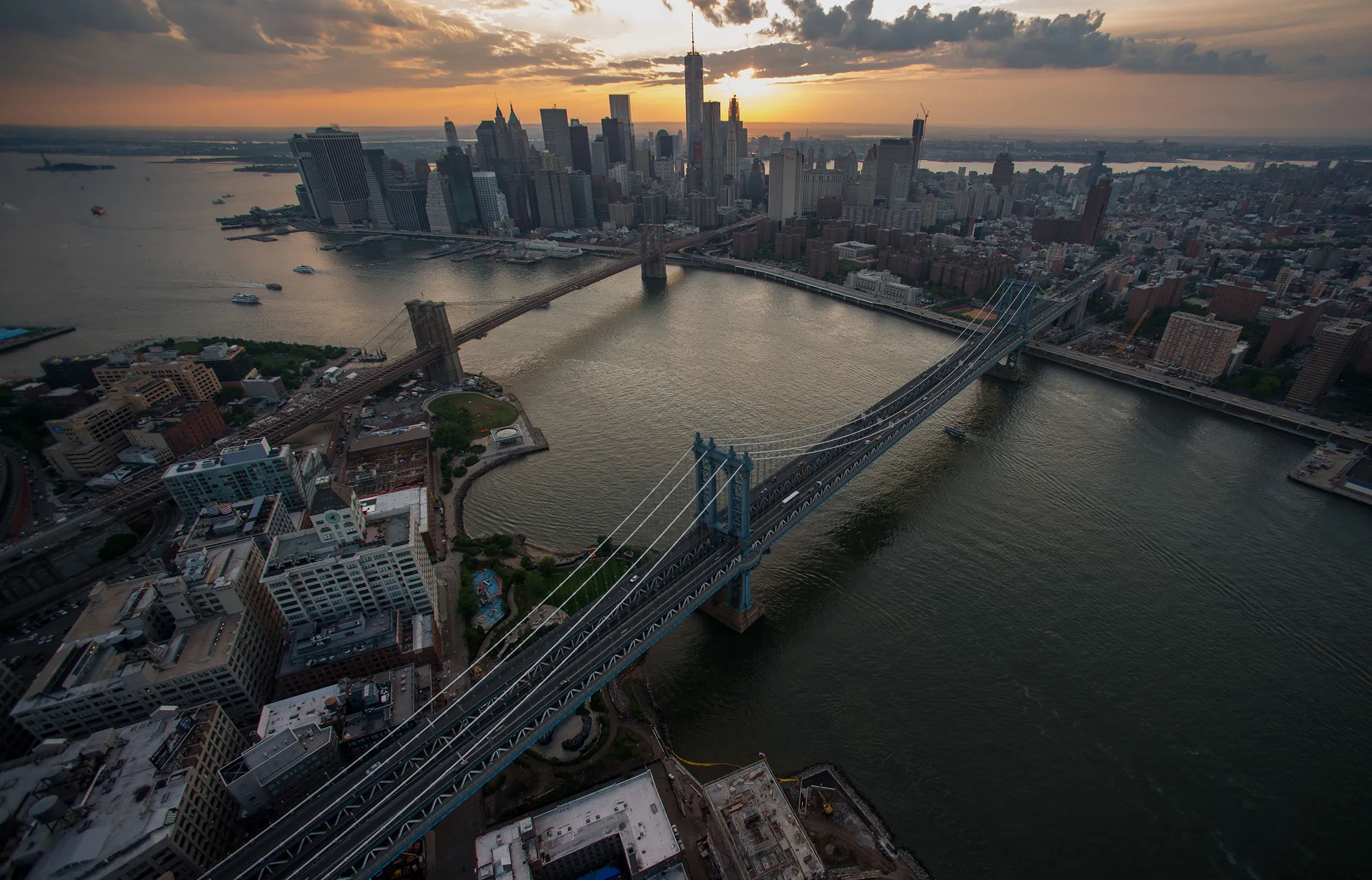The Brooklyn Bridge, left, and Manhattan Bridge stand at dusk in New York.
