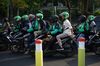 Riders and passengers on Go-Jek motorcycles in Jakarta.