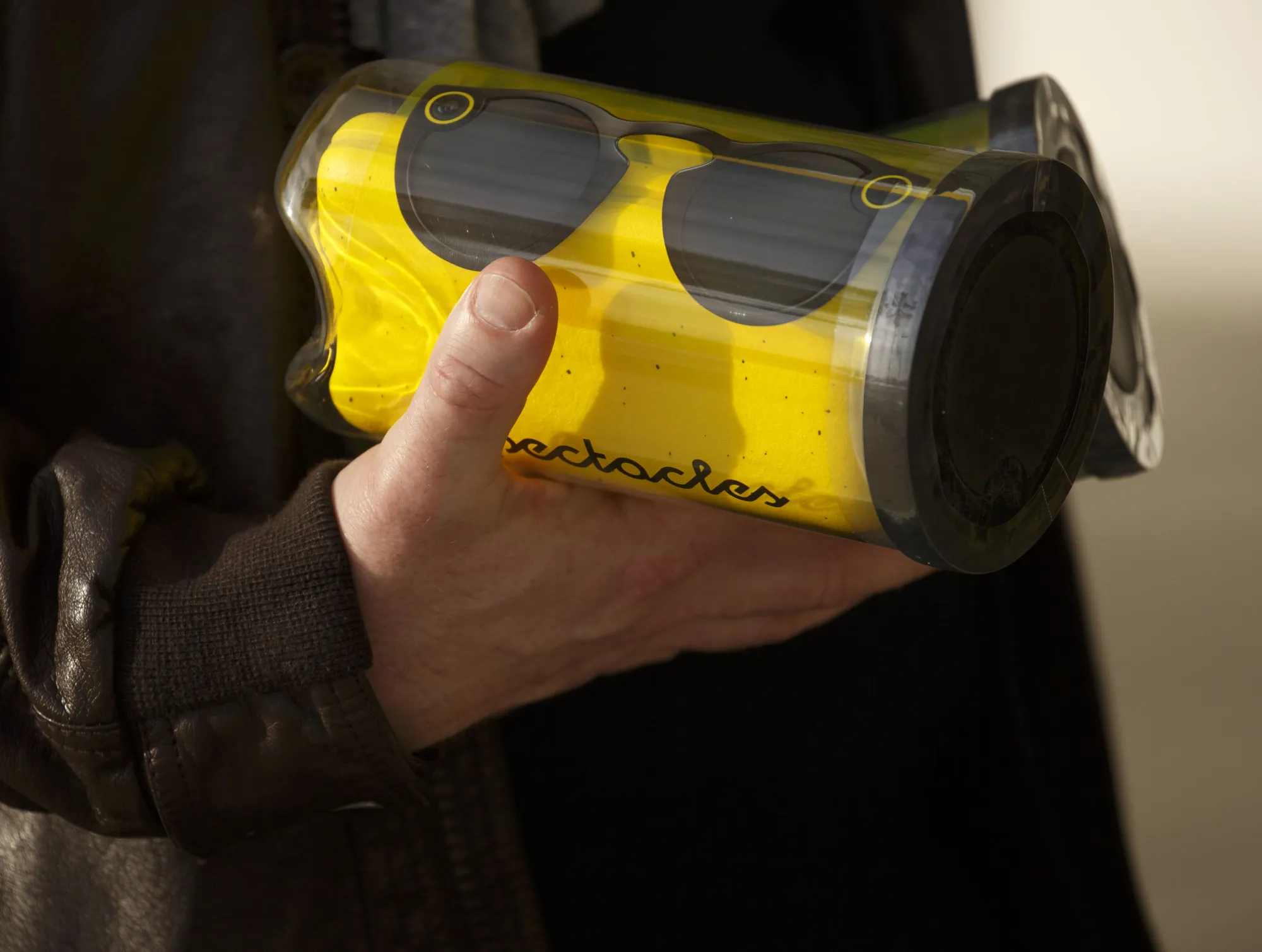 A customer holds tubes containing Snapchat Spectacles by Snap Inc.

