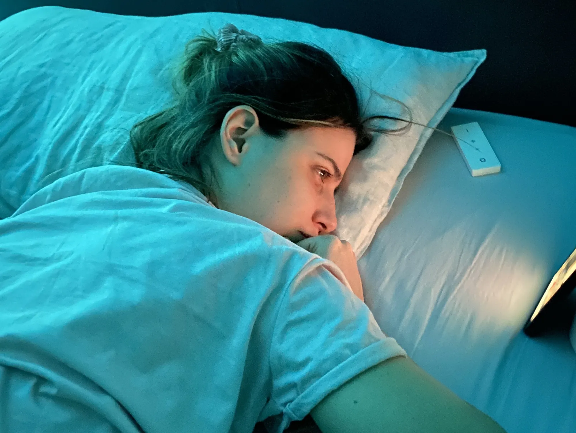 Daniela Alves lies on her front to reduce shortness of breath as she FaceTimes her family.