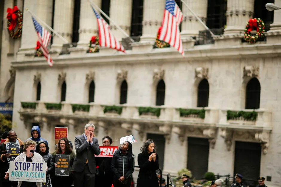 New York City Mayor Bill de Blasio joins protesters rallying against the GOP tax bill. 