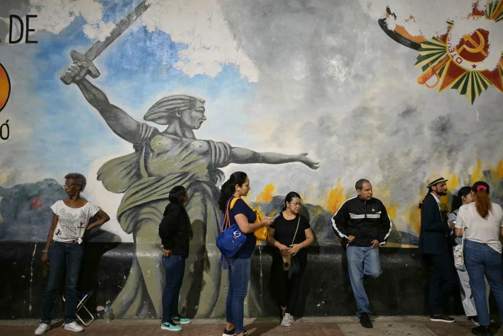 People queue before the opening of polls in Caracas, on July 28.
