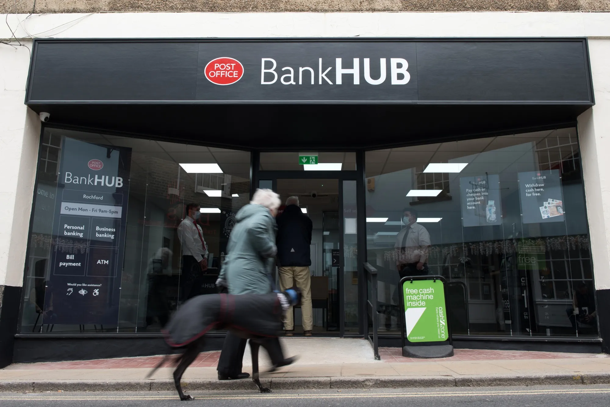 A pedestrian walks past a Bank Hub in Rochford, England.&nbsp;
